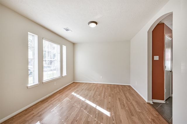 spare room with wood-type flooring and a textured ceiling