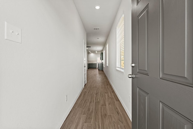 hallway with hardwood / wood-style floors