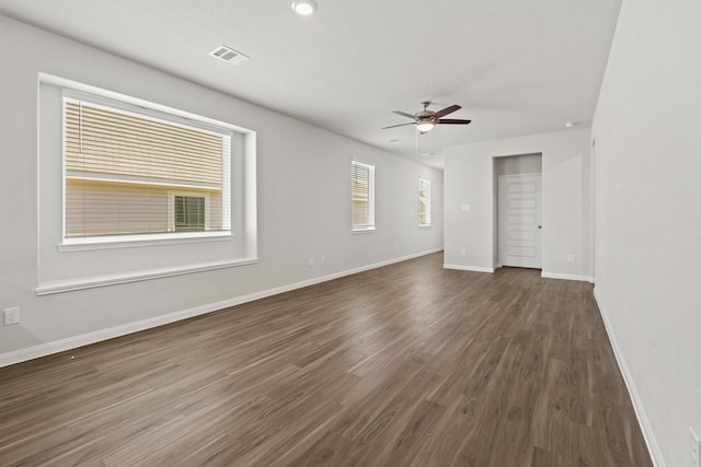 unfurnished room featuring ceiling fan and dark hardwood / wood-style flooring