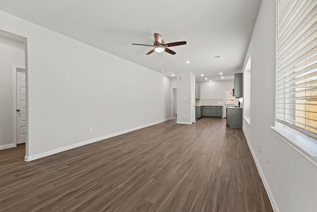 unfurnished living room with ceiling fan and dark hardwood / wood-style flooring