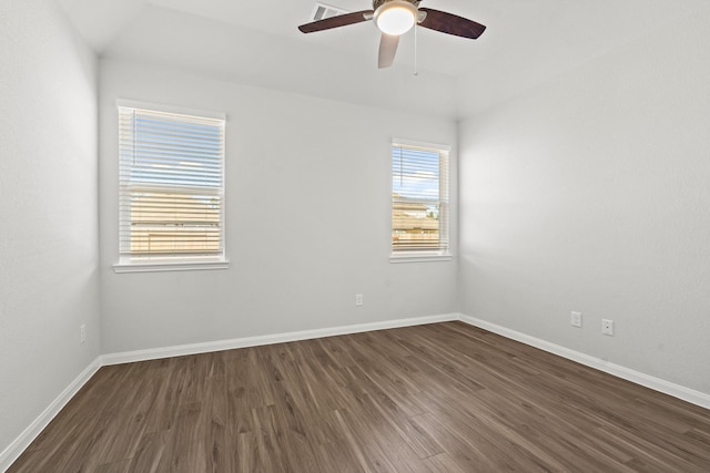 spare room featuring dark hardwood / wood-style flooring and ceiling fan