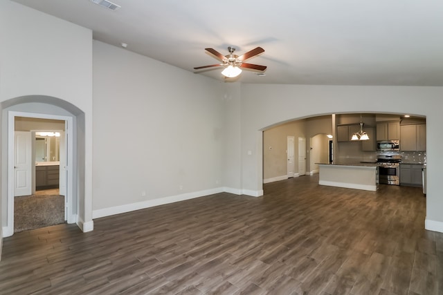 unfurnished living room featuring ceiling fan, high vaulted ceiling, and dark hardwood / wood-style floors