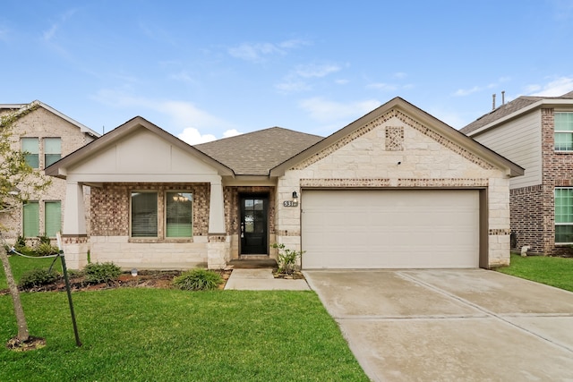 view of front of house with a front yard and a garage