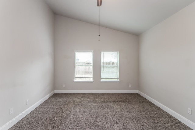 carpeted spare room featuring vaulted ceiling