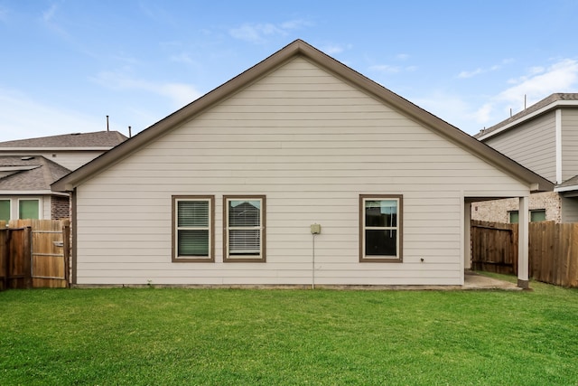 back of property featuring a lawn