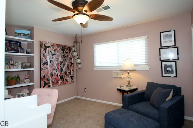 living area with ceiling fan and light carpet