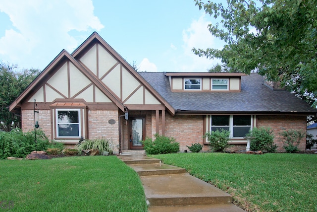 tudor-style house featuring a front lawn