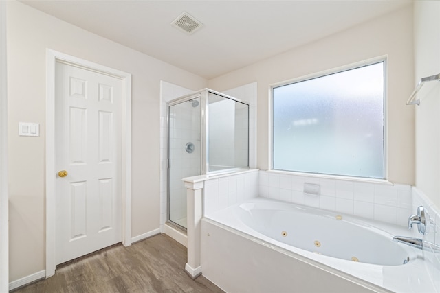 full bath with baseboards, visible vents, wood finished floors, a whirlpool tub, and a shower stall