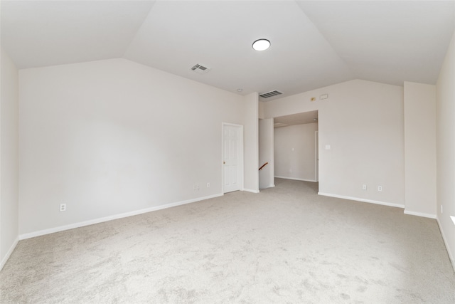 interior space with lofted ceiling, carpet flooring, visible vents, and baseboards