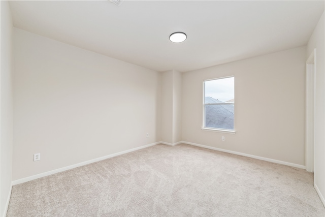 carpeted spare room with baseboards