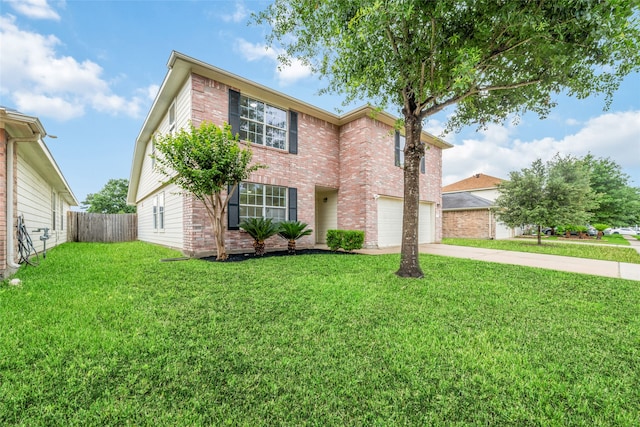 traditional-style home featuring concrete driveway, an attached garage, fence, a front yard, and brick siding