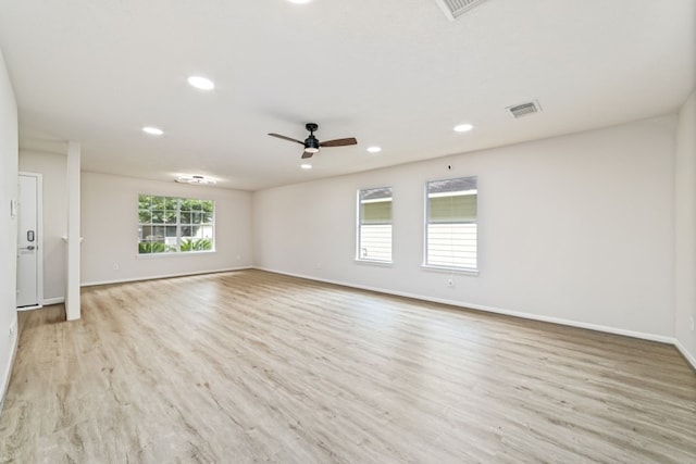 unfurnished room featuring recessed lighting, visible vents, ceiling fan, wood finished floors, and baseboards