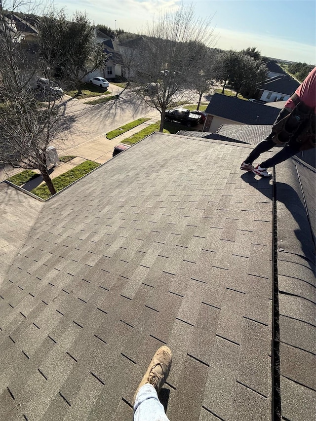 exterior details featuring a shingled roof