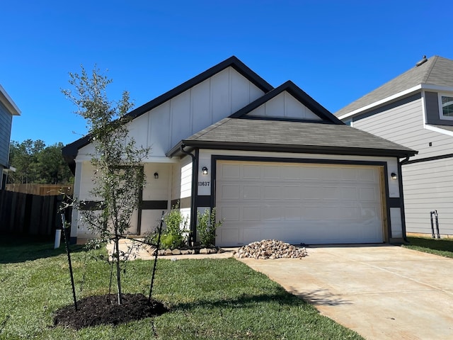 view of front facade featuring a front yard and a garage