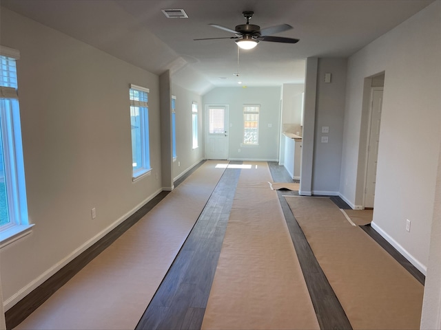 hallway featuring lofted ceiling and hardwood / wood-style flooring