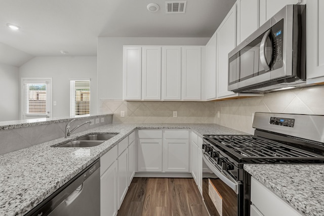 kitchen featuring sink, light stone countertops, white cabinets, and appliances with stainless steel finishes