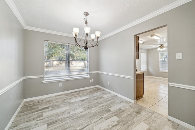 spare room featuring a textured ceiling, plenty of natural light, light hardwood / wood-style floors, and ceiling fan with notable chandelier