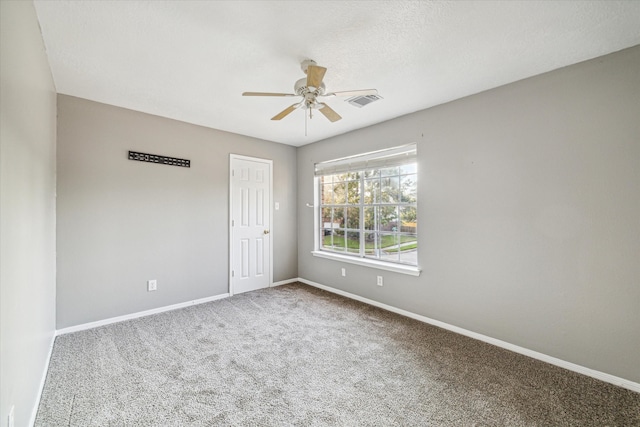 spare room featuring carpet and ceiling fan