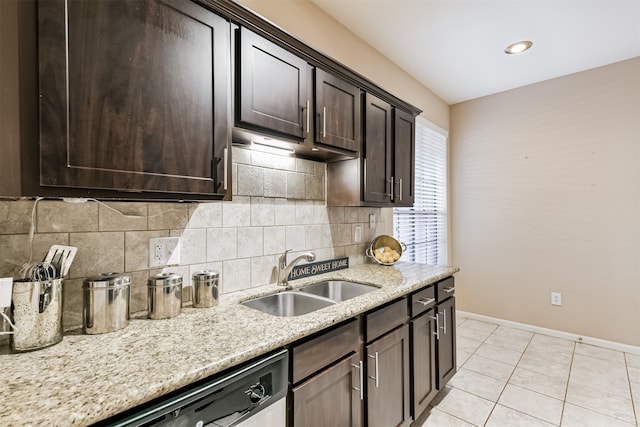 kitchen featuring dishwasher, sink, decorative backsplash, light tile patterned floors, and dark brown cabinets