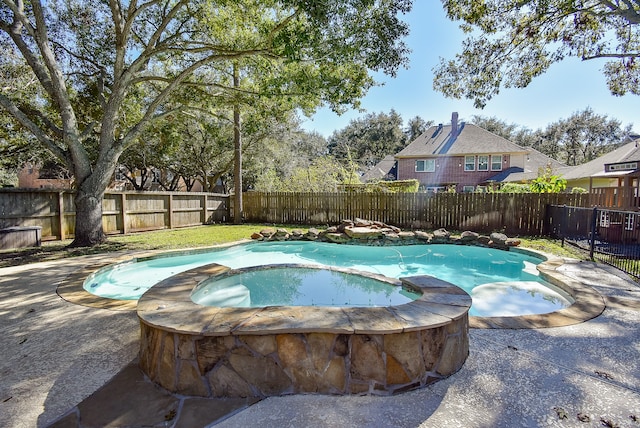 view of pool with an in ground hot tub