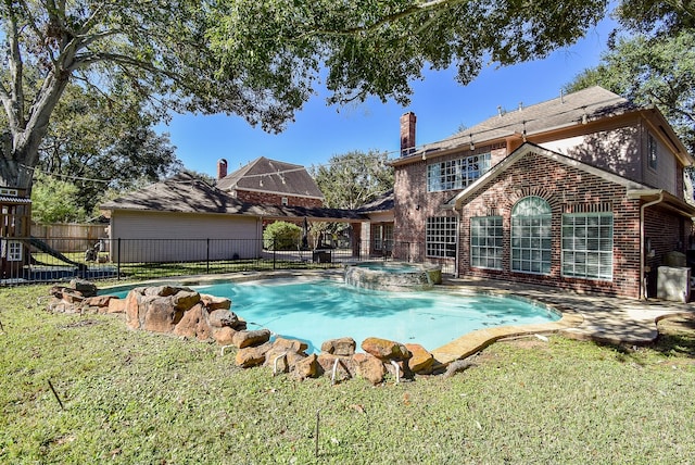 view of pool featuring an in ground hot tub, a yard, and a patio area