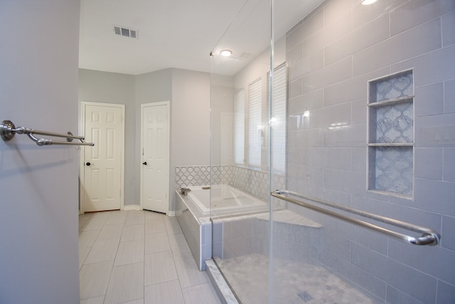 bathroom featuring separate shower and tub and tile patterned floors