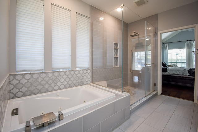 bathroom featuring shower with separate bathtub