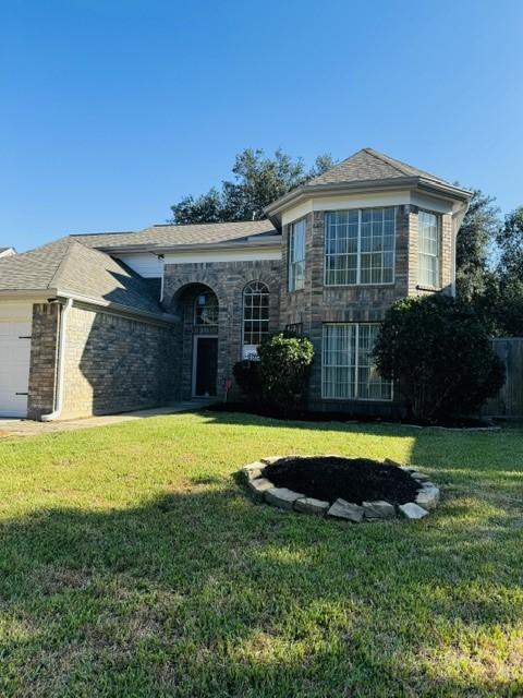 view of front of house with a garage and a front yard