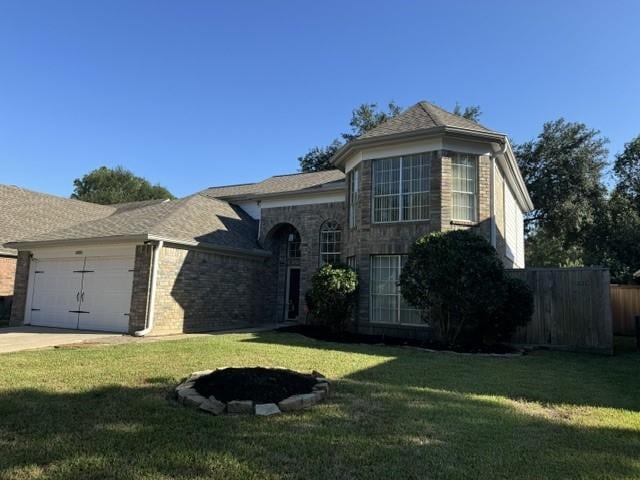 view of front facade with a front yard and a garage