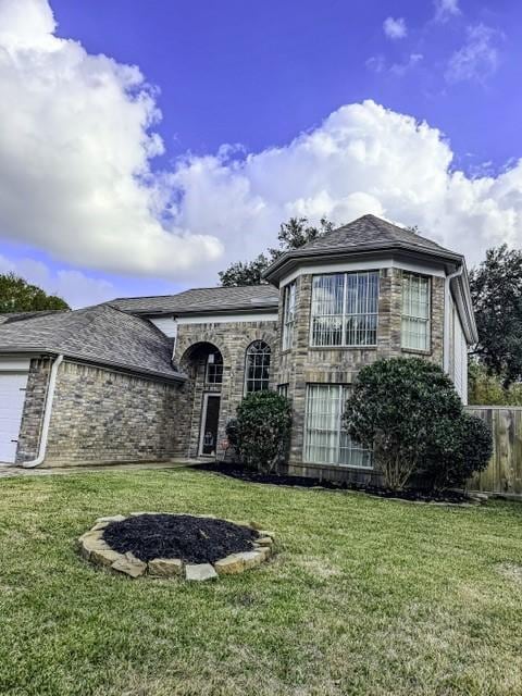 view of front of property featuring a front yard and a garage