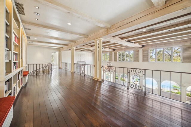 interior space with beam ceiling and ornate columns