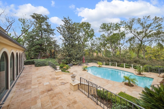 view of swimming pool featuring a patio area