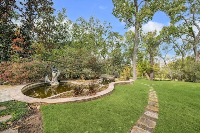 view of property's community with a lawn