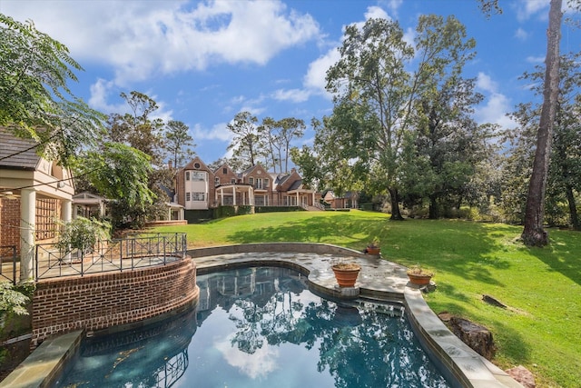 view of pool with a deck and a yard