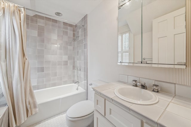 bathroom featuring toilet, shower / tub combo, and vanity