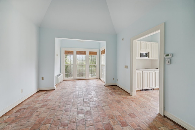 unfurnished room featuring vaulted ceiling