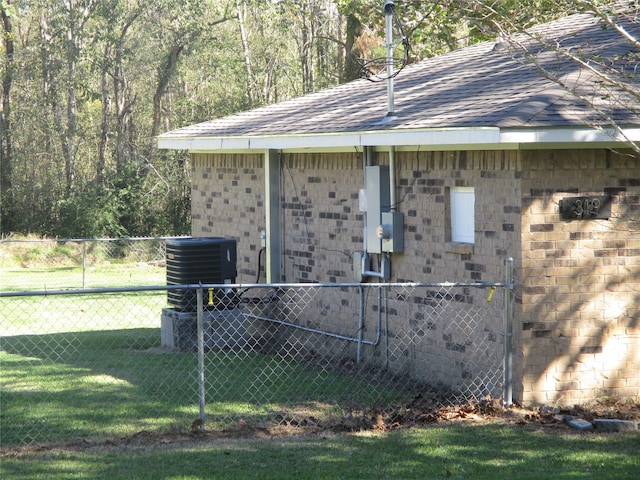 exterior space featuring a yard and central AC