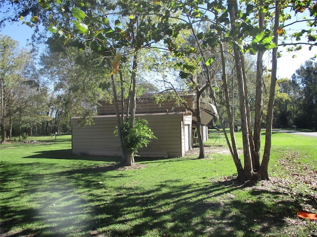 319 River Rd, Goodrich, TX 77335 - view of grassy yard with an outdoor structure and a storage unit