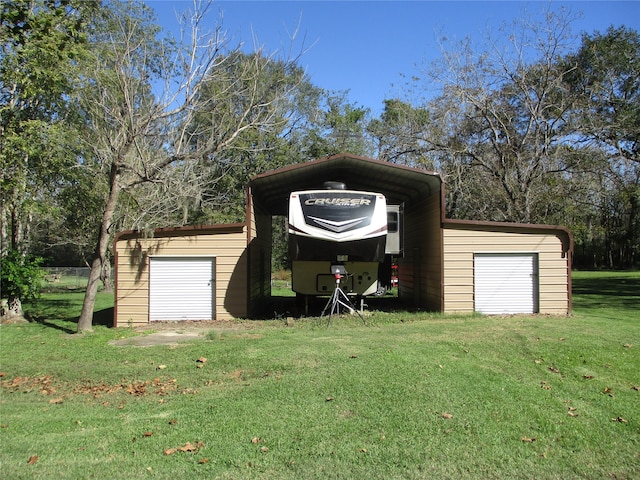 view of outbuilding featuring a garage, a carport, and a lawn