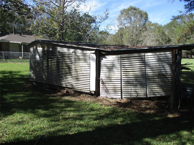 exterior space featuring a lawn and a shed