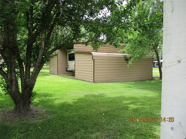 319 River Rd, Goodrich, TX 77335 - view of green lawn featuring an outdoor structure and a shed