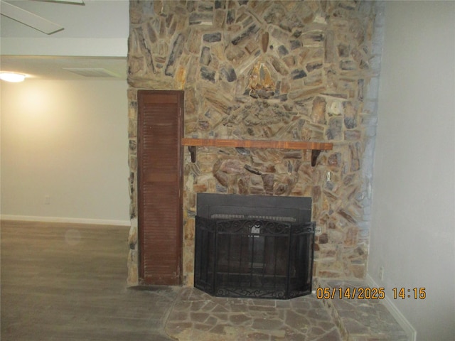 319 River Rd, Goodrich, TX 77335 - detailed view of baseboards, wood finished floors, and a stone fireplace