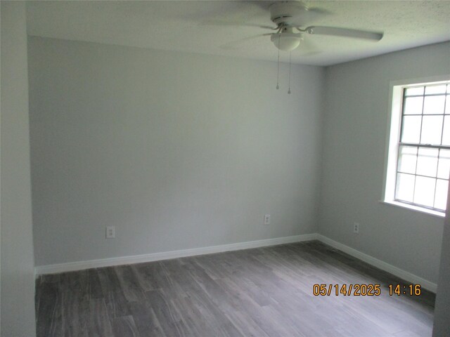 319 River Rd, Goodrich, TX 77335 - unfurnished room with a ceiling fan, plenty of natural light, wood finished floors, and baseboards