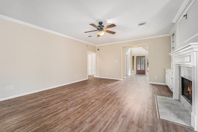 unfurnished living room featuring a fireplace, wood-type flooring, a textured ceiling, and ornamental molding