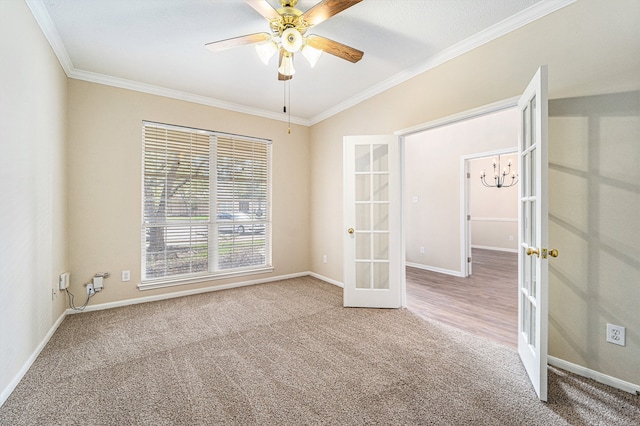 spare room featuring carpet flooring, crown molding, and french doors