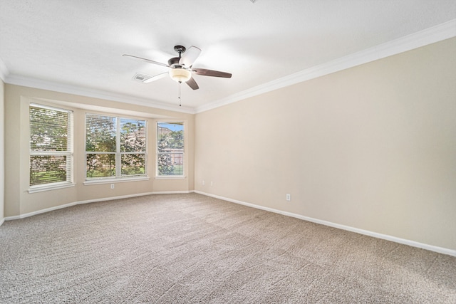 carpeted spare room with ceiling fan and crown molding