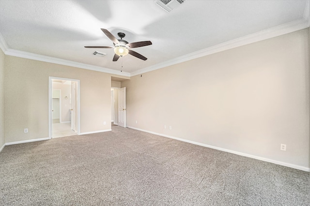 spare room featuring carpet flooring, a textured ceiling, ceiling fan, and ornamental molding