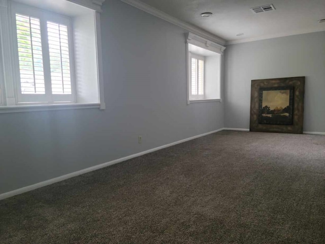 unfurnished living room with dark colored carpet and ornamental molding