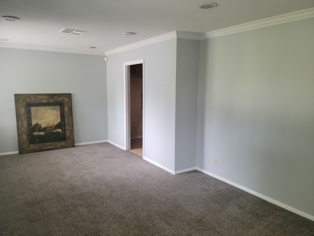 unfurnished living room with carpet and crown molding