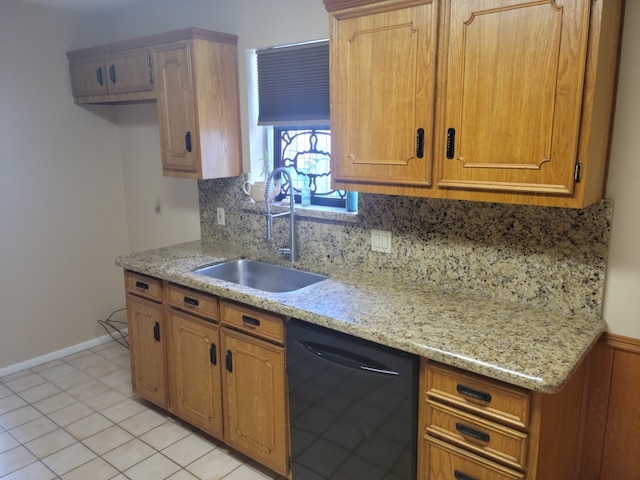 kitchen with decorative backsplash, light stone countertops, sink, light tile patterned floors, and dishwasher